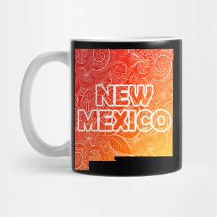 Colorful mandala art map of New Mexico with text in red and orange Mug